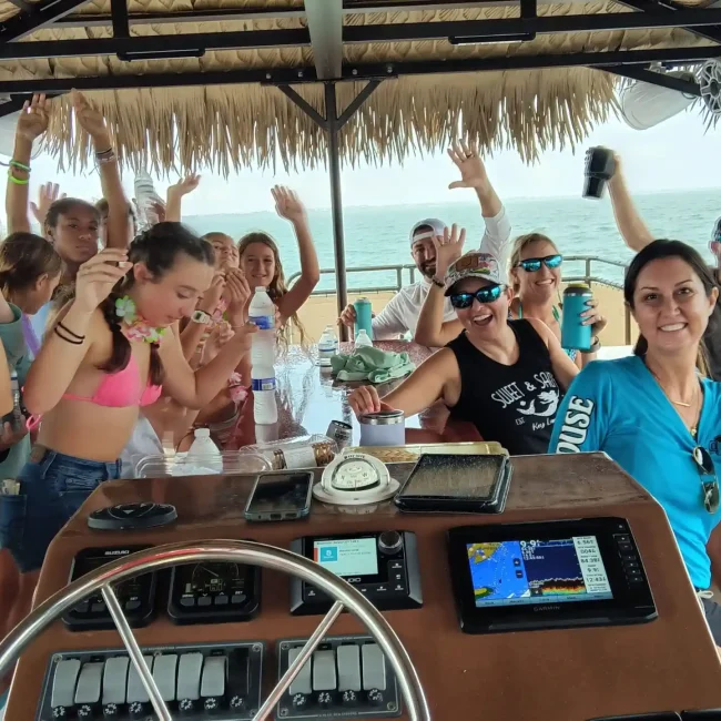 A group of people enjoying a Key Largo tiki tour with Bluetooth sound system.