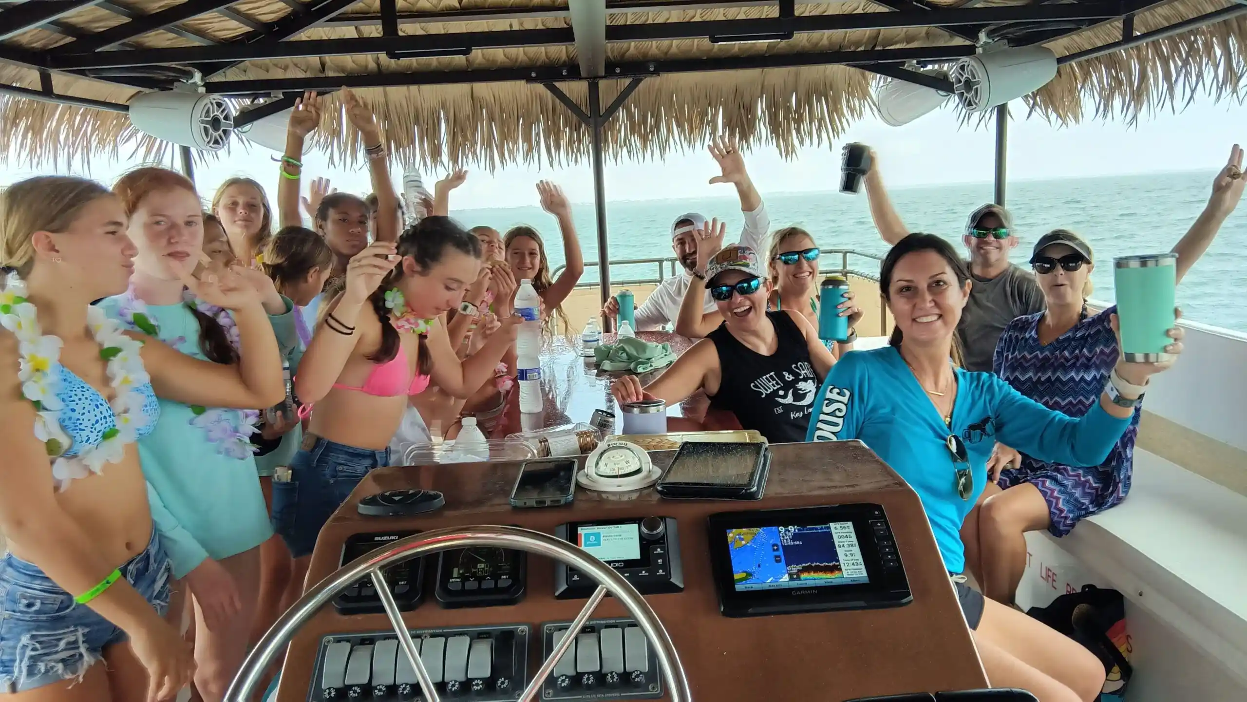 A group of people enjoying a Key Largo tiki tour with Bluetooth sound system.