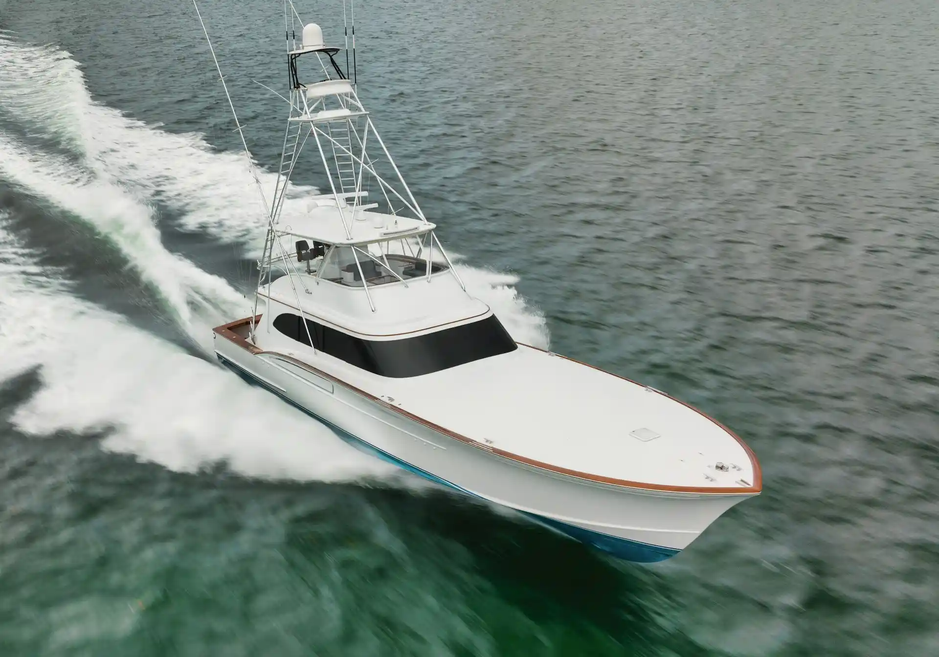 A sleek, white sport fishing yacht speeding through the water, creating a large wake, prompting thoughts on the need for boat rental insurance.